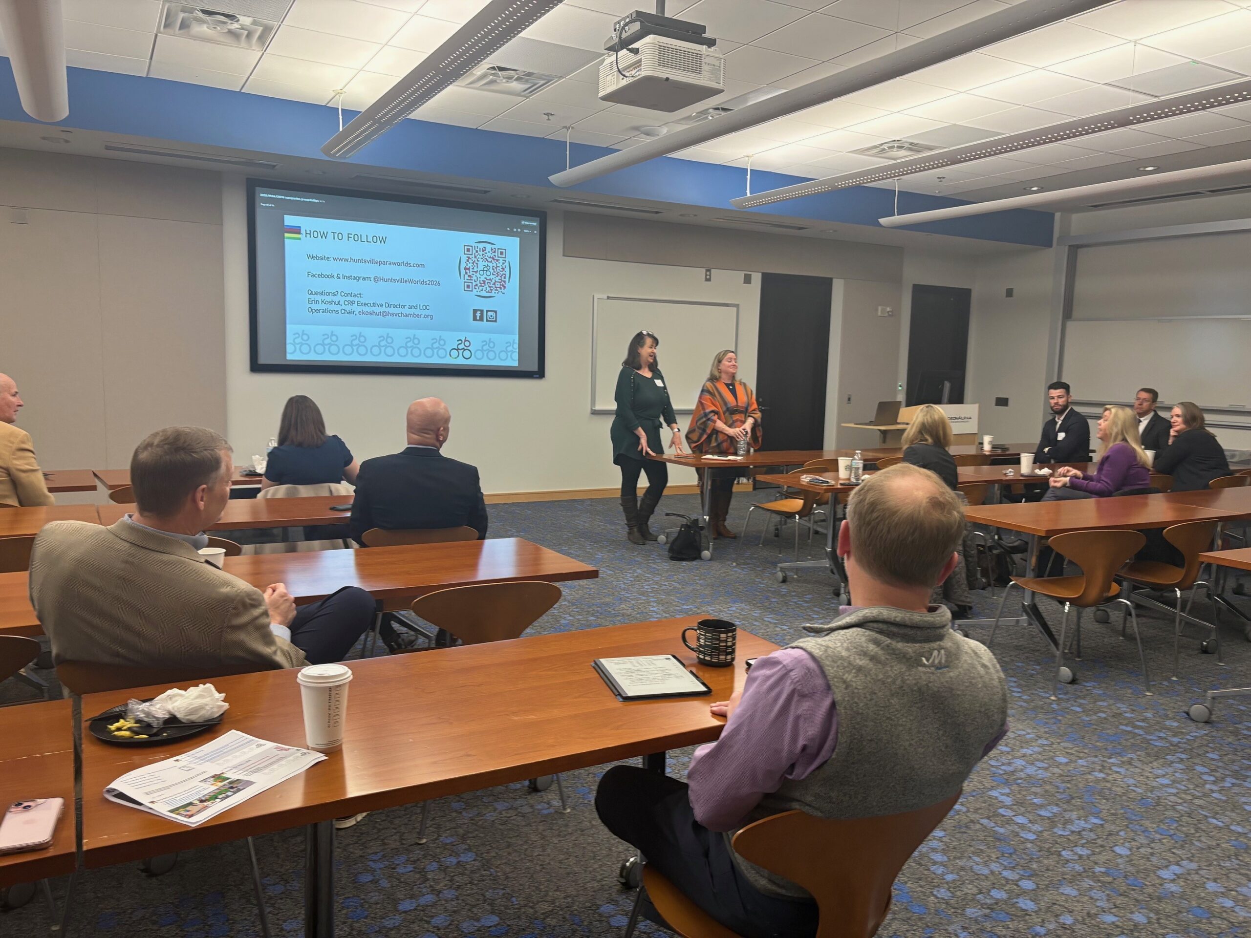 Claire Aiello & Erin Koshut present information to company leaders in Cummings Research Park about the 2026 races.